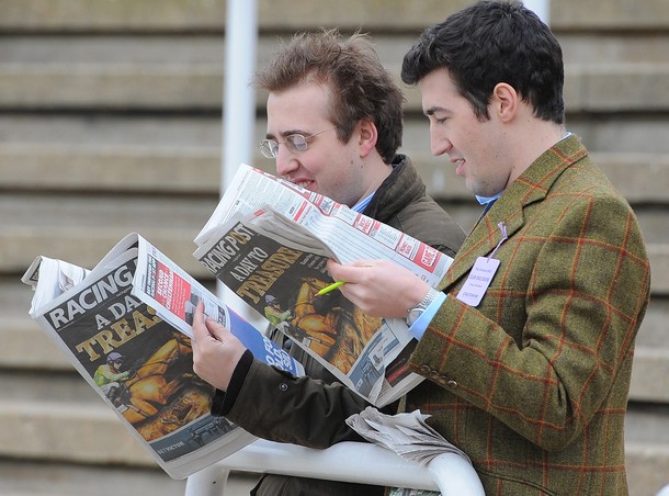 Racegoer's check their papers on the las