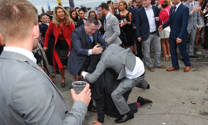 A fight breaks out on Ladies Day of the Grand National Festival 2014 at Aintree