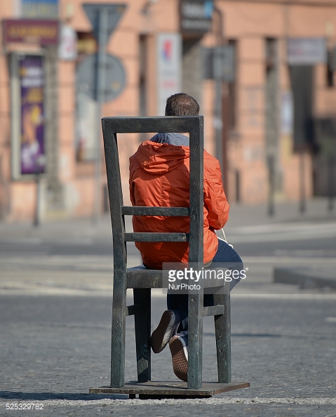 A young person seating and contemplating on one of the many of iron chairs, a part of Krakow's Getto Memorial, as many Cracovians and guests from other cities and other countries gather at the Ghetto Heroes Square in Krakow to pay homage to all cracovian Jews murdered during the Holocaust. Then all together march along the route which for many of them in 1943 was a road to death - to a site of former KL Płaszów. Sunday 15 March 2015. Photo by Artur Widak/NurPhoto (Photo by Artur Widak/NurPhoto)